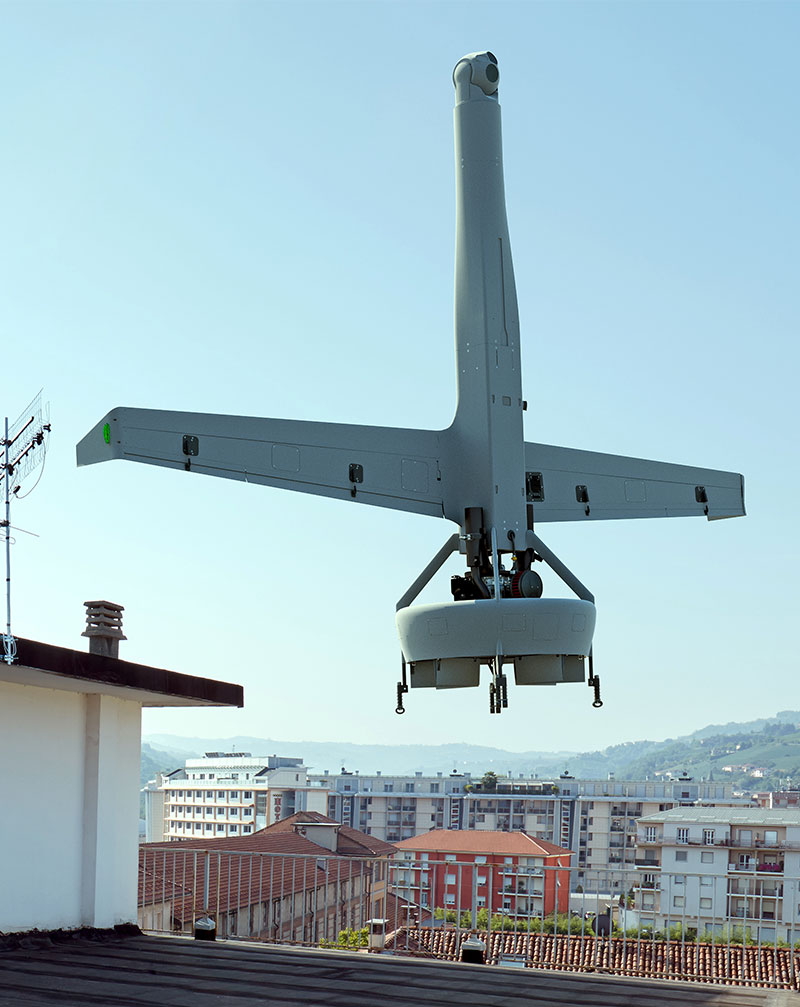 Unmanned aircraft flying above building
