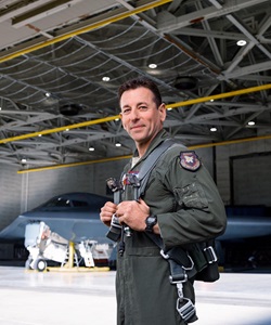 airman in hangar in front of stealth airplane