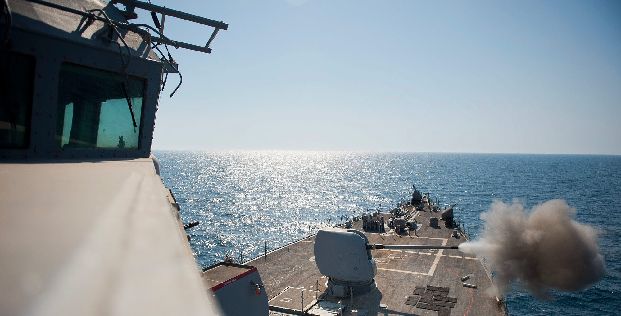 guided missile destroyer at sea firing gun
