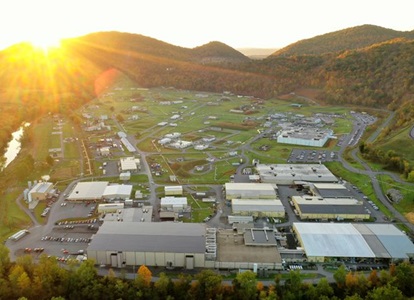 aerial view of a factory at sunrise.