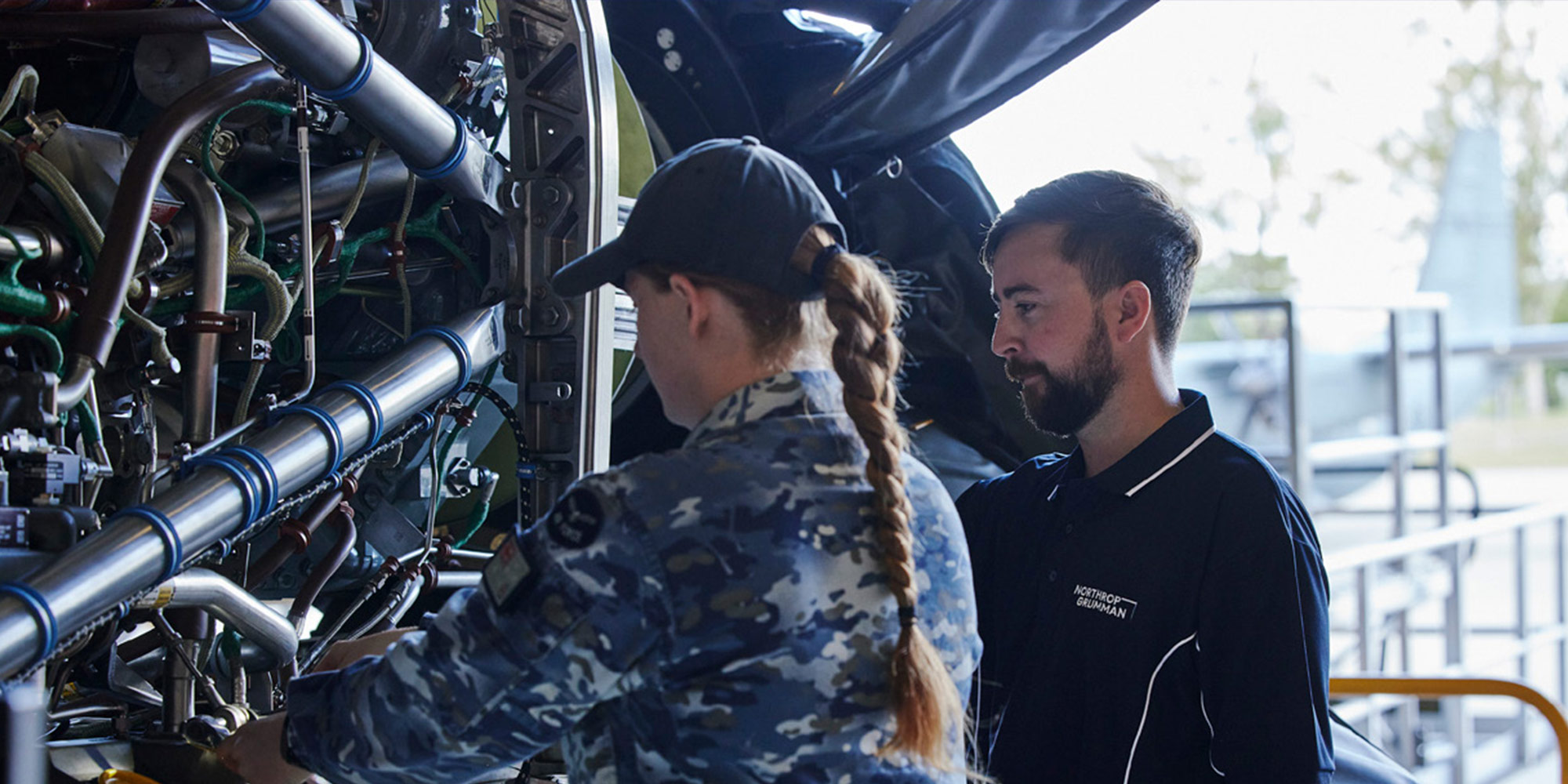 Northrop Grumman Australia male employee working with female teammate on military aircraft