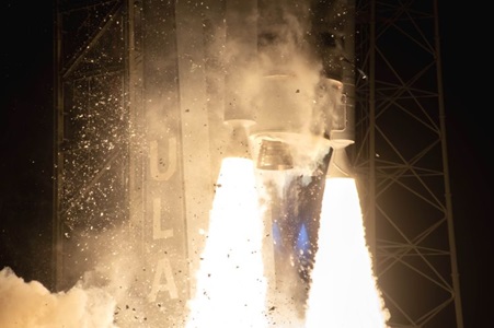 rocket engines firing on launchpad