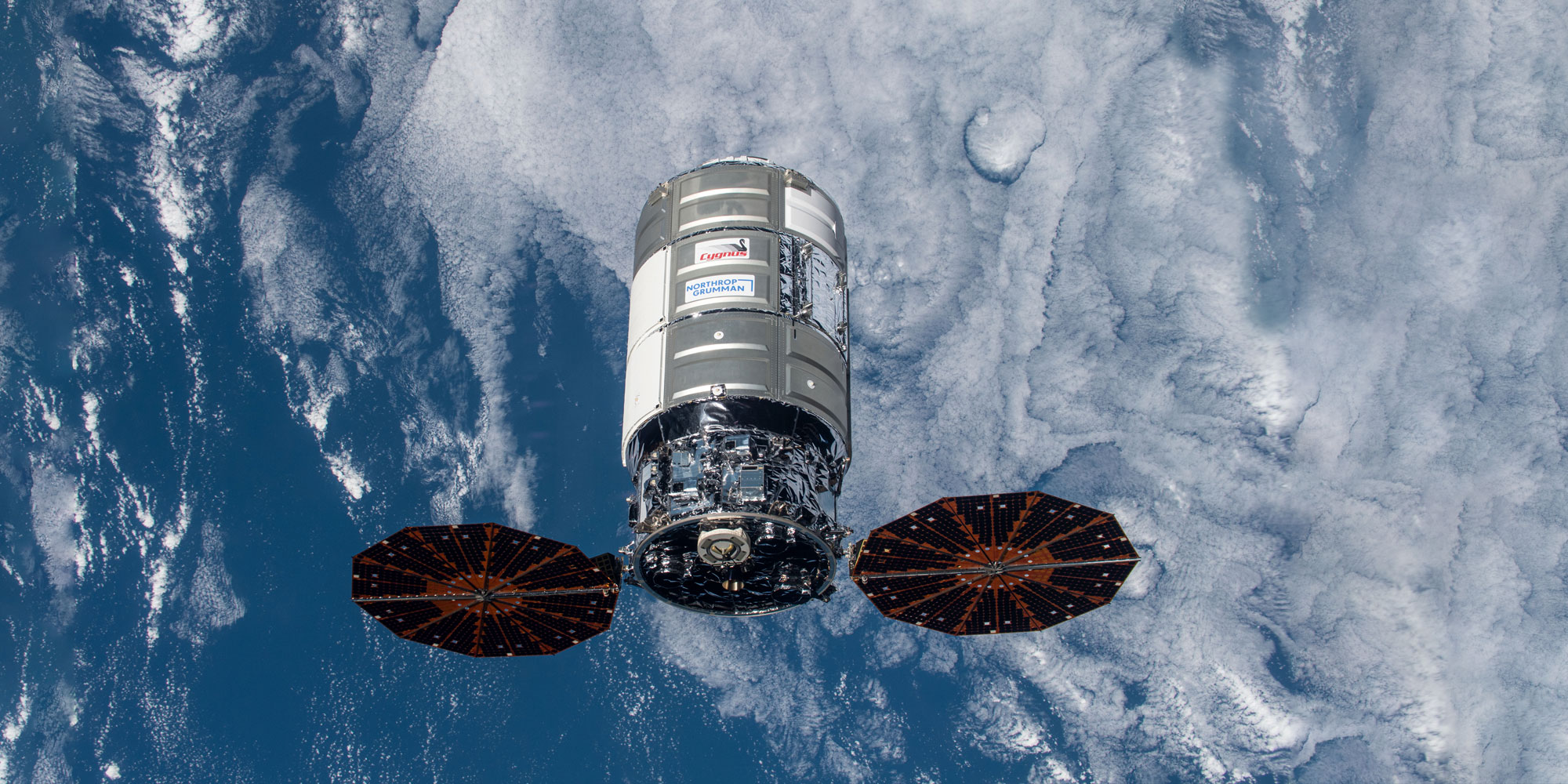 Cygnus spacecraft above earth clouds and ocean