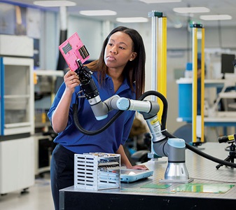 technician working with robotic arm.