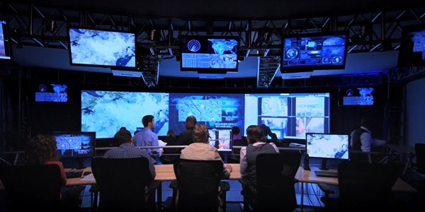 Employees sit in control room