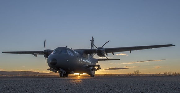 Military aircraft with sunset behind it