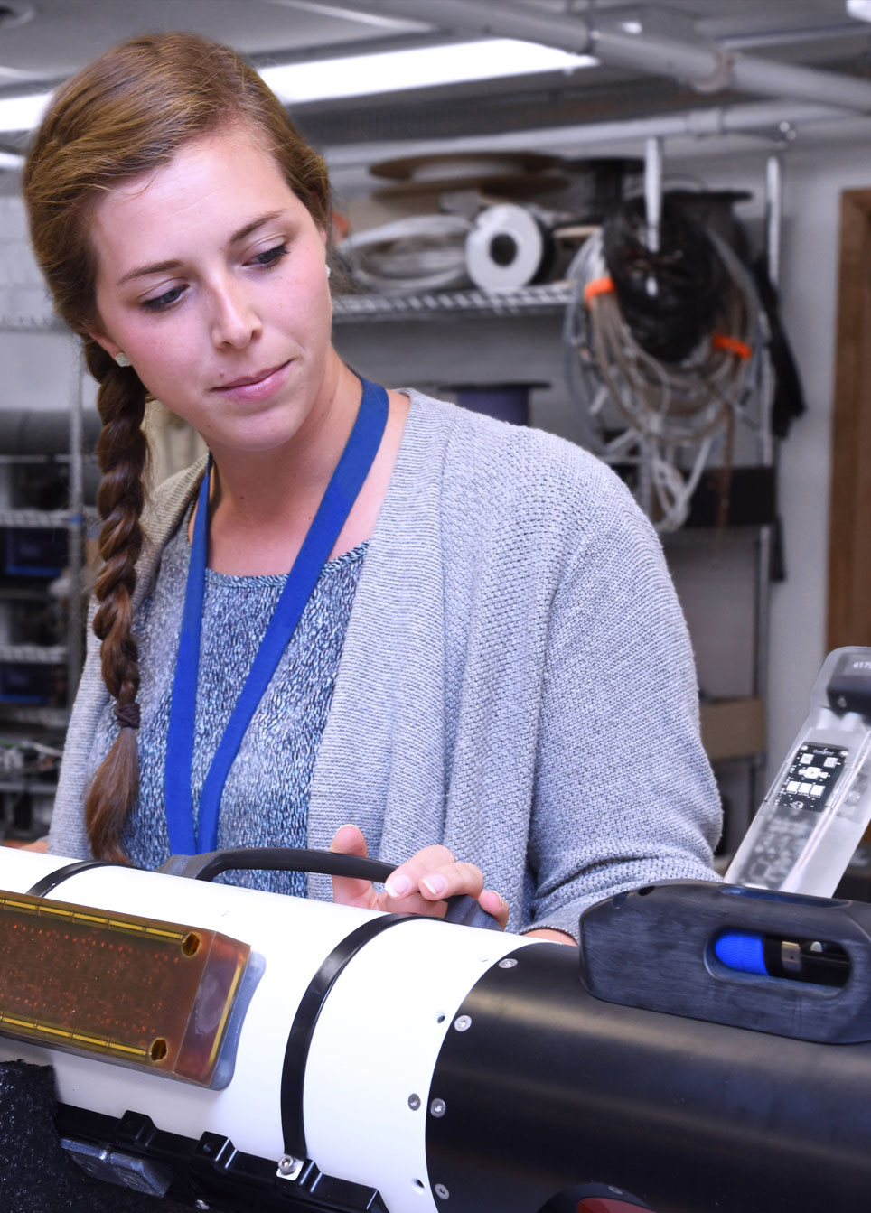 Lauren Lagua, senior principal systems engineer at Northrop Grumman, adjusts the µSAS sensor on an unmanned underwater vehicle.