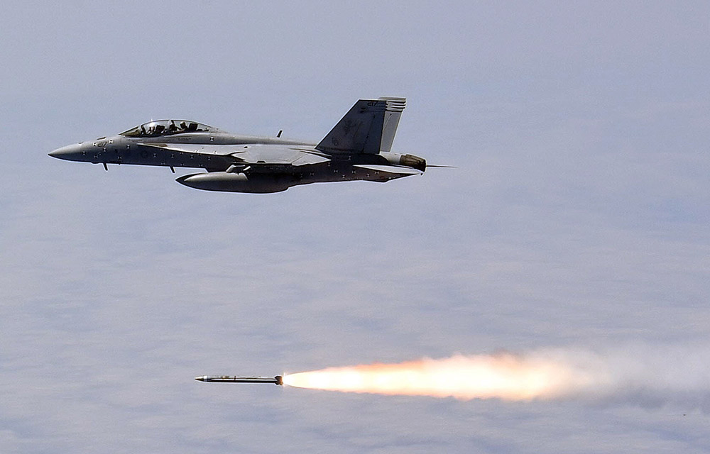 U.S. military jet inflight, firing rocket