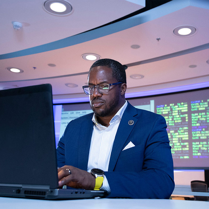 black male digital design engineer using laptop