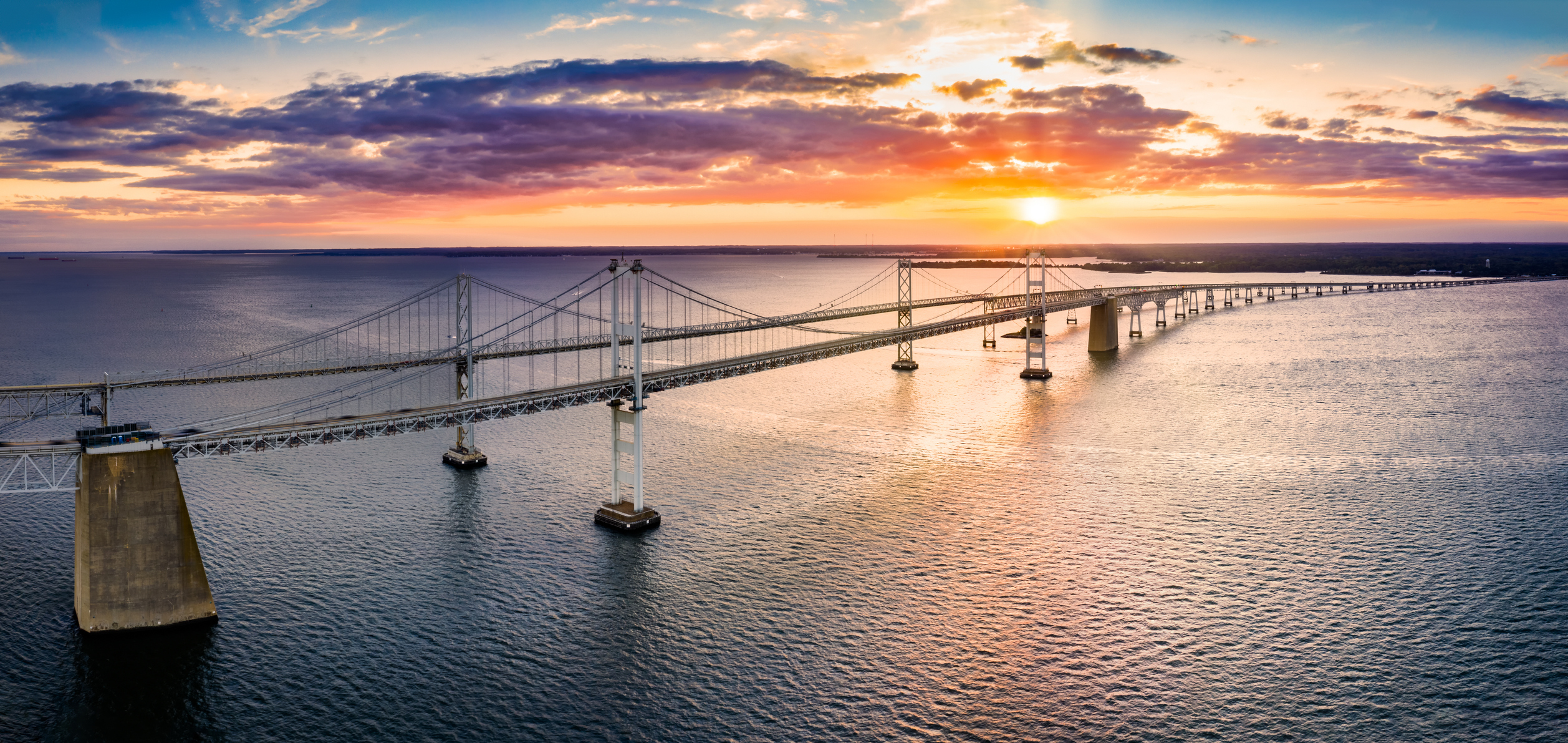 Aerial view of Chesapeake Bay Bridge at sunset.