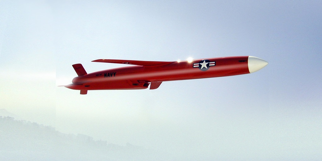 orange aircraft inflight against blue sky