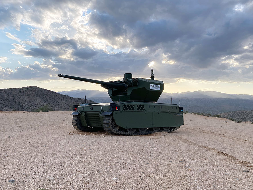 a green military tank at rest in the dessert