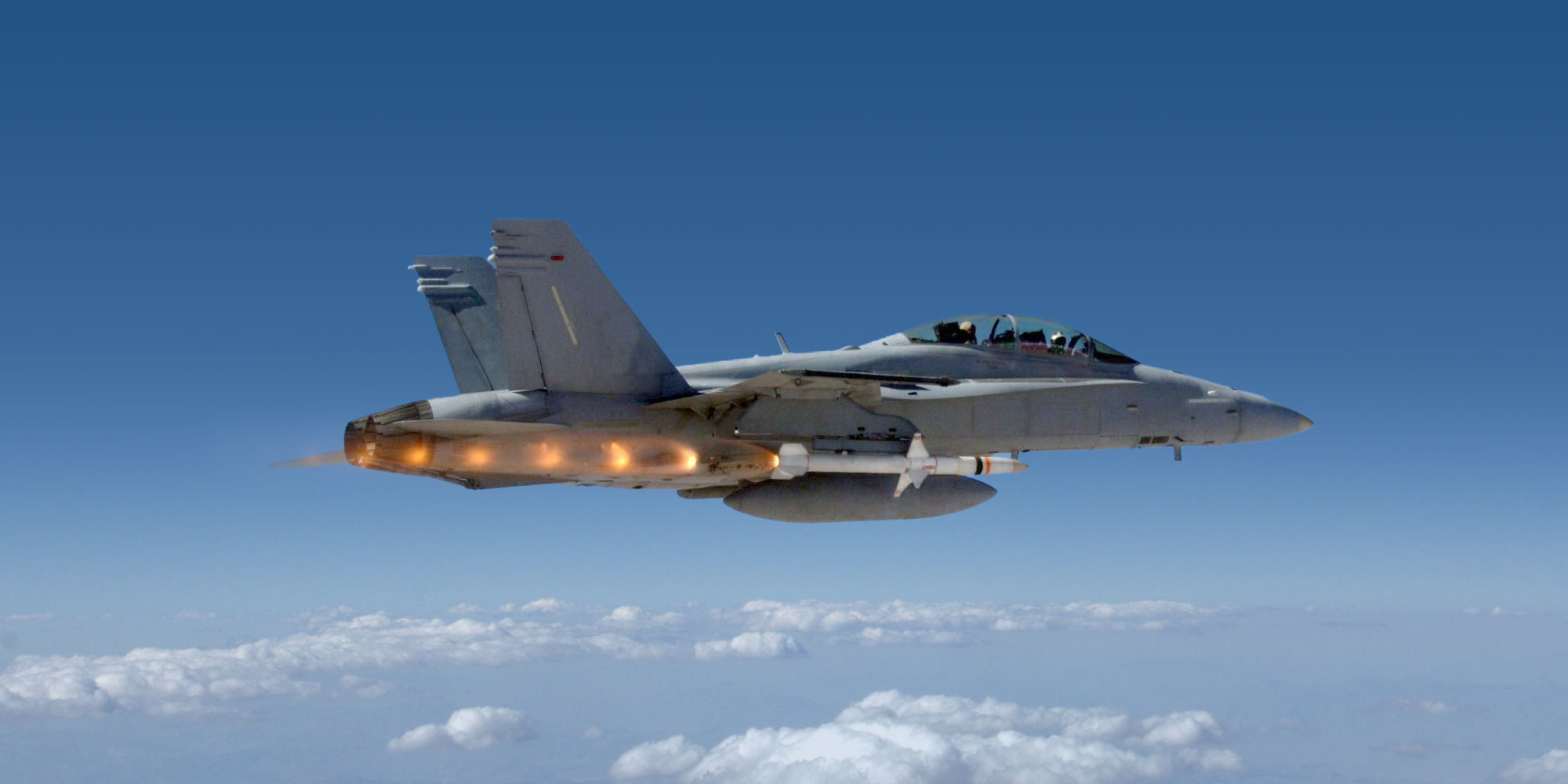 Fighter jet shooting Advanced Anti-Radiation Guided Missile AARGM above blue skies