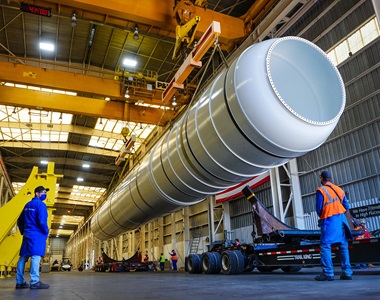 a solid rocket booster being loaded on a trailer