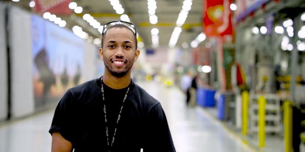 black man smiling in large hangar