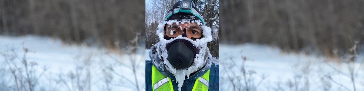 male with mask on covered in snow