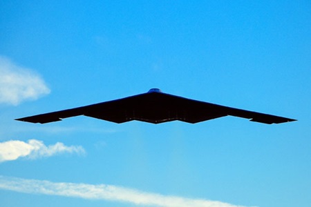 stealth flying wing over blue skies
