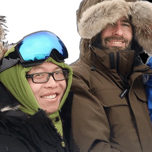 two people smiling in cold weather gear