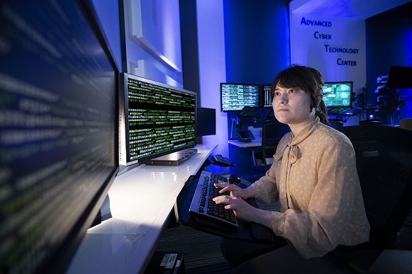 Woman sitting at computer looking at monitor