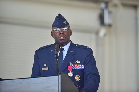 Black man in Army uniform speaks at podium