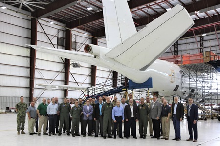 People standing under tail of Navy E-6B Mercury aircraft