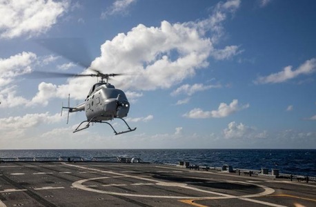 Helicopter landing on deck of a naval ship