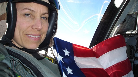 white woman fighter pilot holding flag