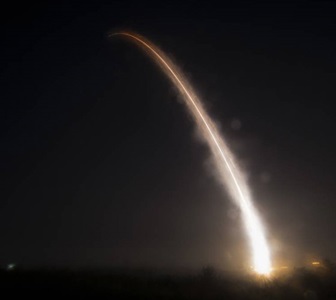 missile flying into the night sky