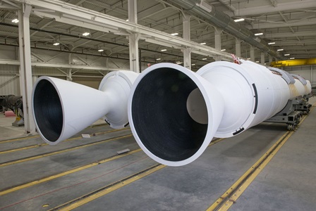 Two white large rocket motor boosters at the Promontory, Utah, facility