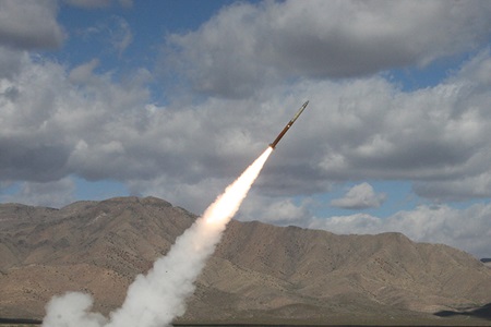 Rocket being launched against cloudy sky and mountains Rocket
