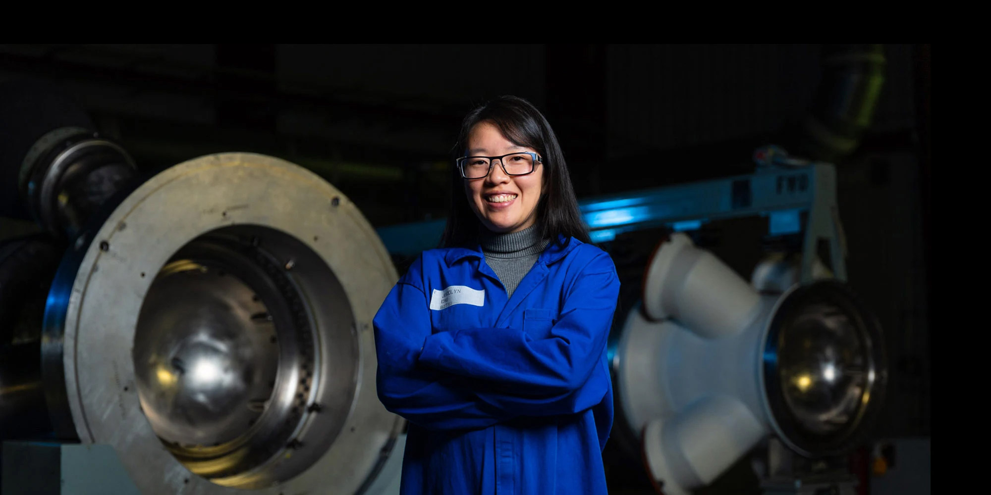 Female employee smiling with arms crossed