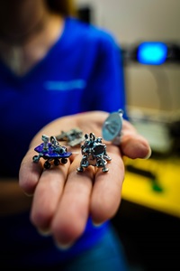 Woman holding 3D printed jewelry in palm