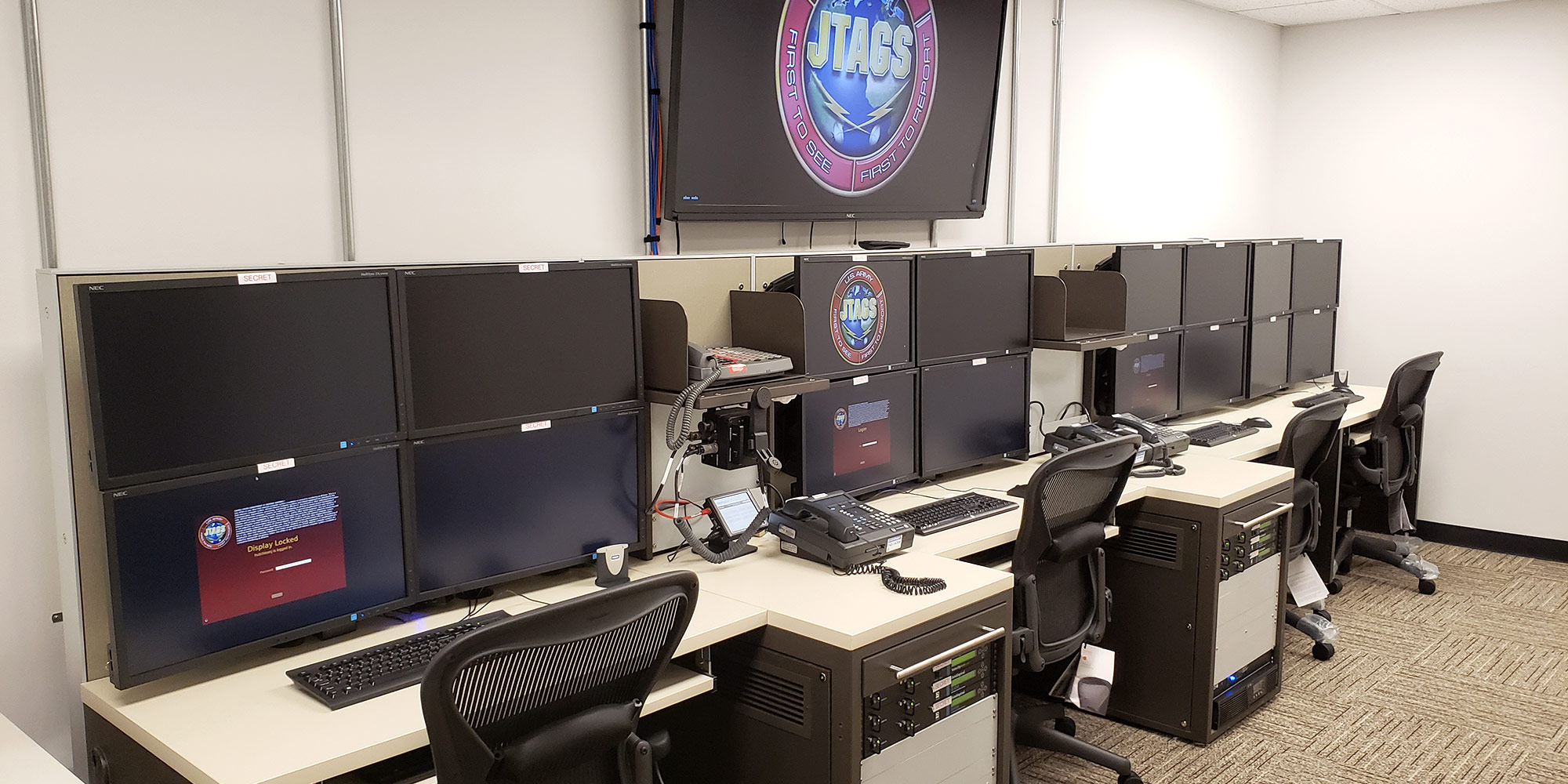 Row of computer monitors for Joint Tactical Ground Station JTAGS