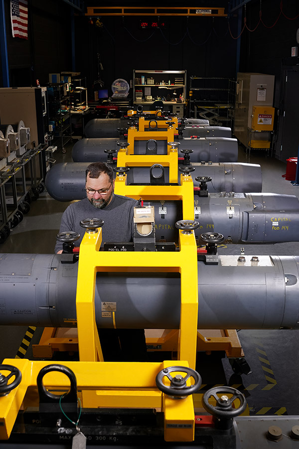 man working on pod assembly line