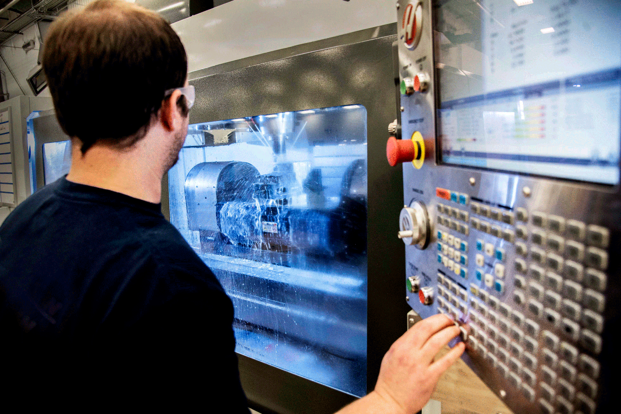 a man uses a control panel to adjust a machine