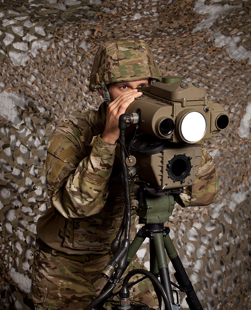 military man viewing into laser rangefinder