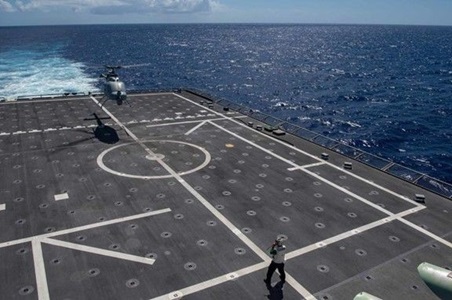 helicopter landing a deck of navy ship