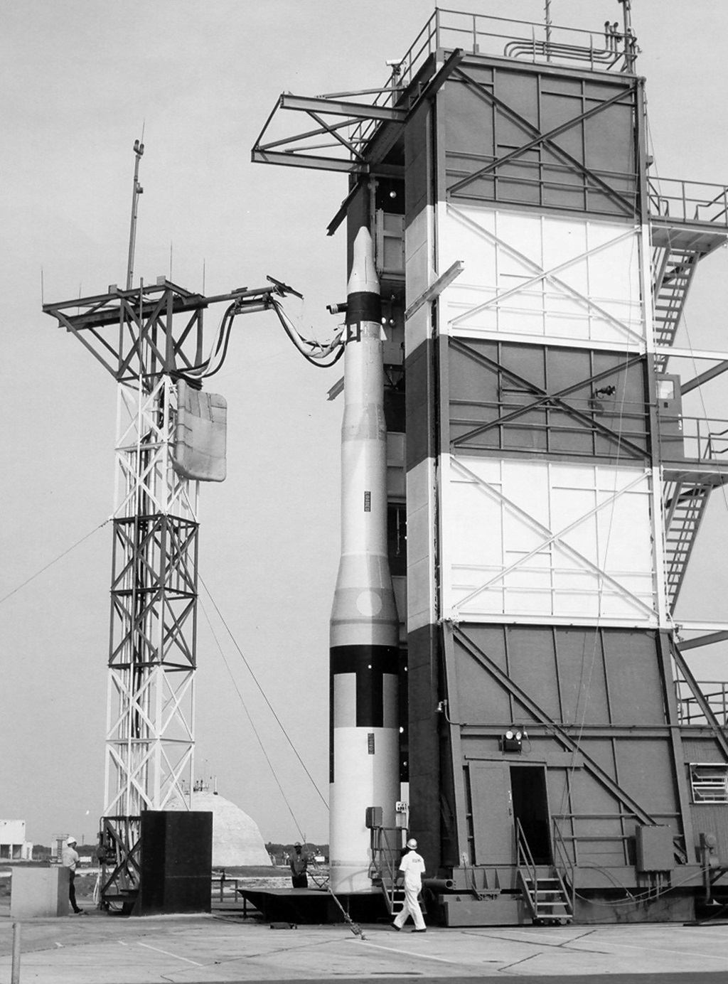 Rocket on launch pad with man in front