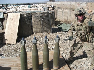 Solider setting up 155mm artillery projectiles