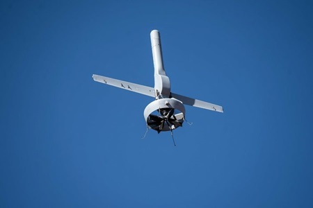 unmanned aircraft flying upward in blue sky