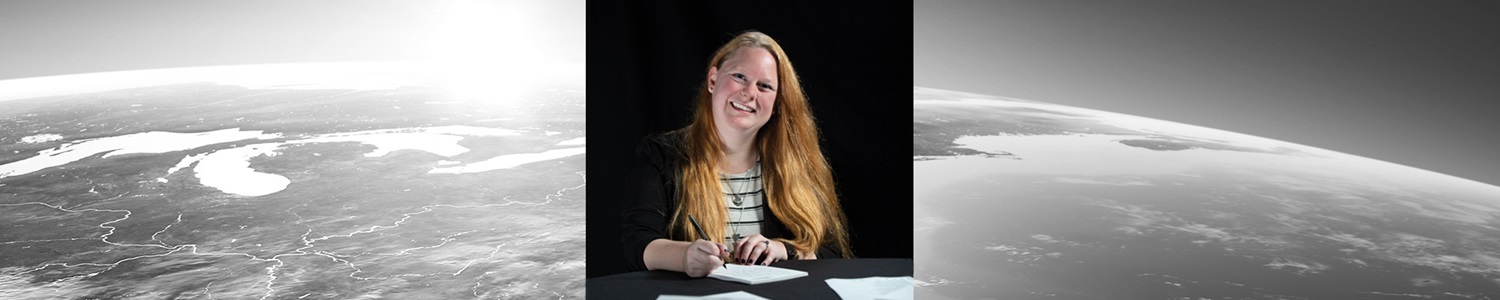 woman smiling while writing a note