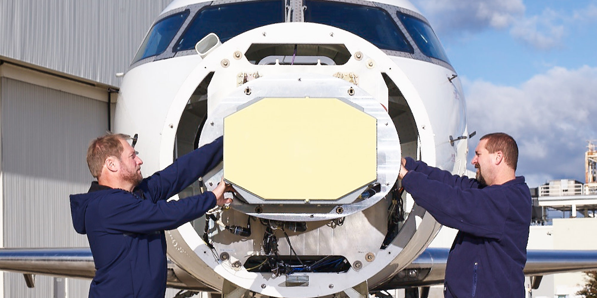 men installing radar in nose tip of airplane