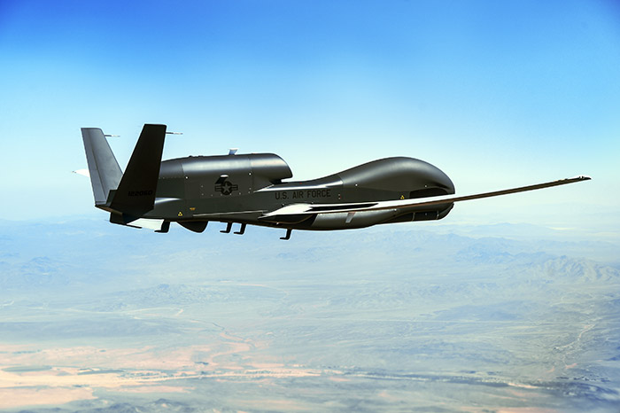 USAF Global Hawk flying over desert