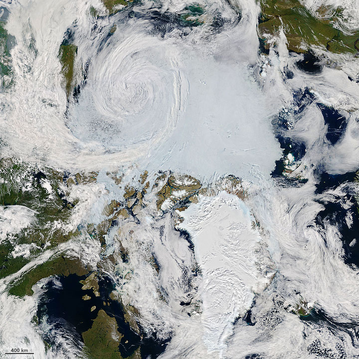 A satellite’s view of the Arctic, shown as a swirl of white, green and dark blue