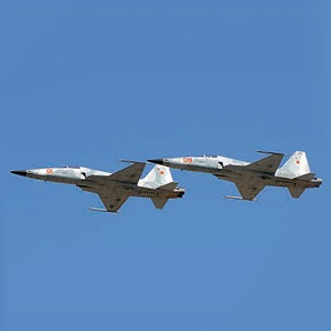 2 fighter jets inflight against blue sky