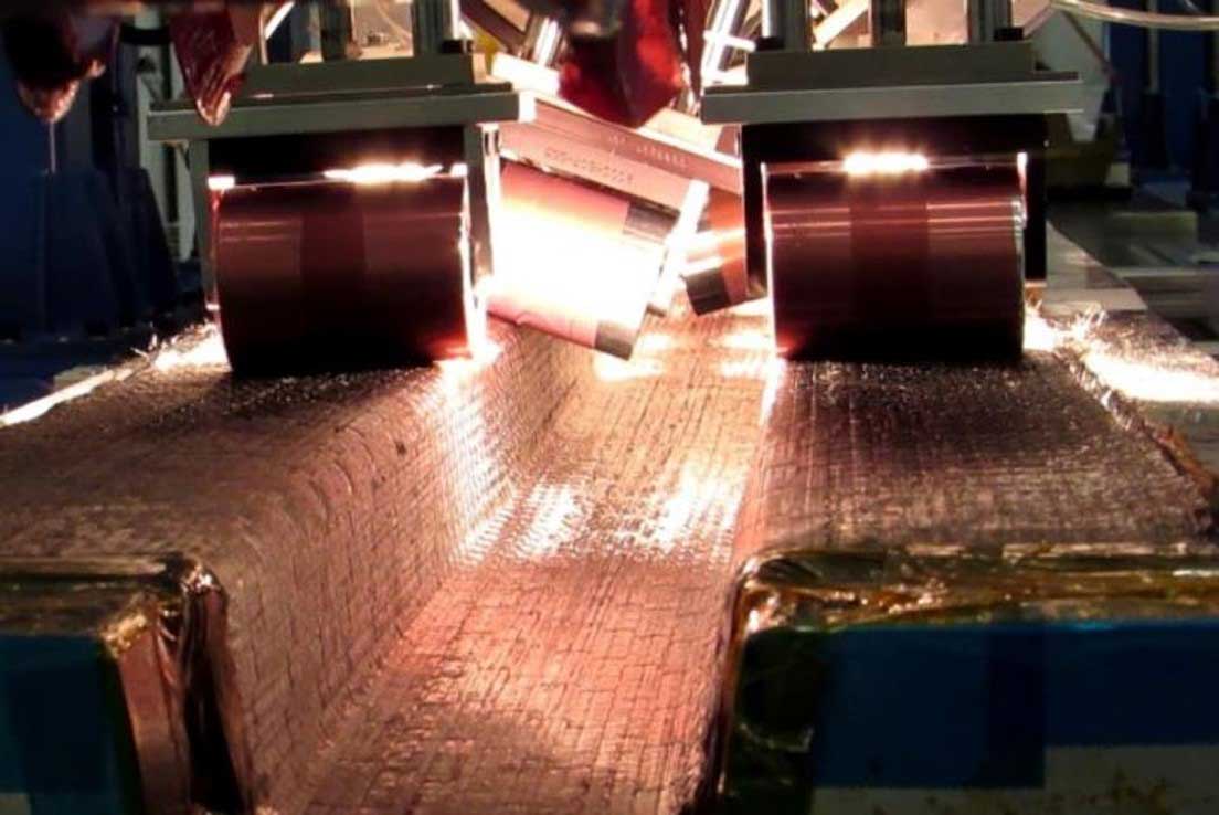 A close-up of an automated stiffener forming (ASF) machine