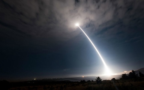 Missile shooting into the sky at night
