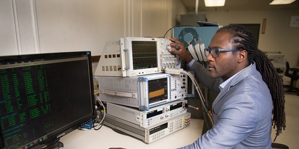 Black man working on metrology calibration devices
