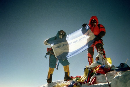 Northrop Grumman engineer summits Mt. Everest and displays the northrop grumman flag.