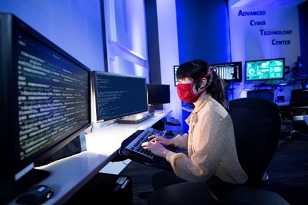 women reading multiple computer screens